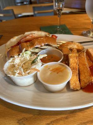 New England lunch with lobster  roll, sweet potato  fries and coleslaw.