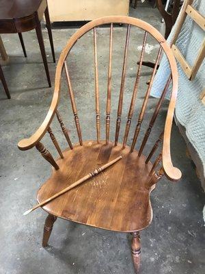 A broken spindle on the back of this Windsor chair.