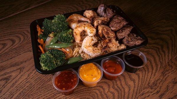 LUNCH BOWL TRIO                    Steak, chicken, and shrimp over fried rice and vegetables