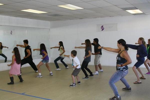 kids kung fu class, with moms joining in the back