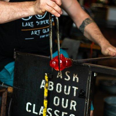 One of our staff glassblowers creating a Glass Rubber Duck