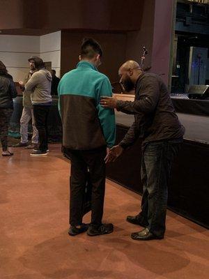 Pastor Brandon giving my son a special prayer for his knee