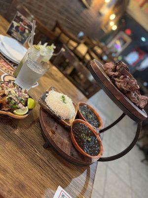 Steak, rice, black beans, and ceviche.