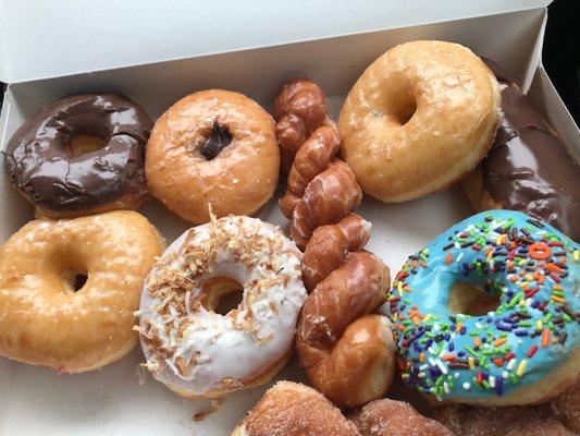 Chocolate frosted, filled chocolate bar, chocolate filled donut, cinnamon sugar twist, toasted coconut, plain glazed