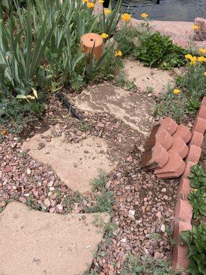 The two bricks were on the left where the only partially buried hose is, the pavers were not covered in rock and dirt