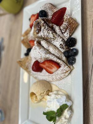 Crepes with ice cream filled with fruit.