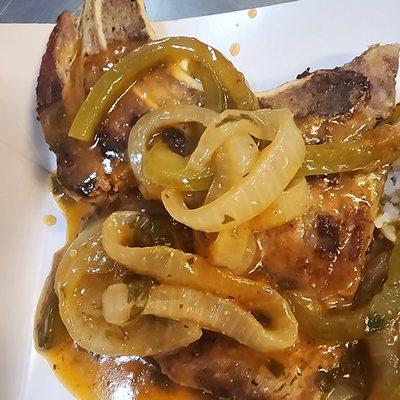 Grilled center-cut pork chop topped with an onion & pepper sauce.