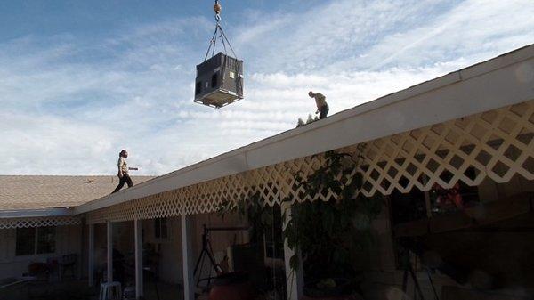 Brian had a crane put our new heat pump into place on the roof.