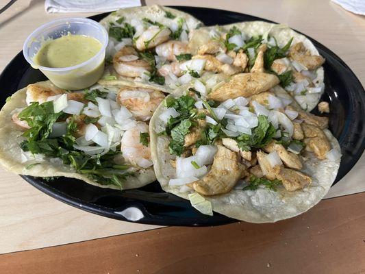 Two shrimp and two chicken tacos.