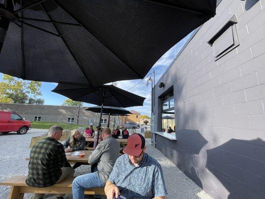 Side of the outdoor seating area, near food truck.