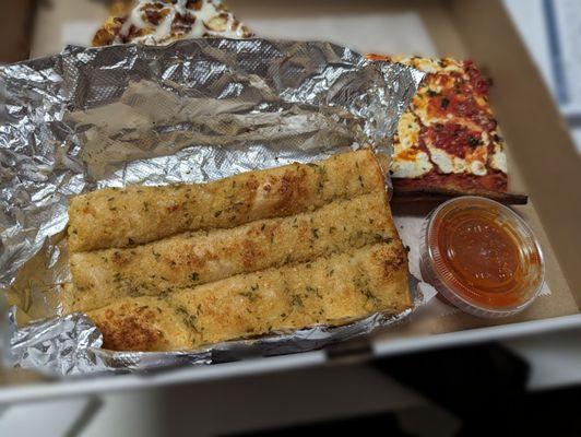 12/20/2023 Garlic bread sticks, with the option of cheese and comes with tomato sauce. Quick tasty.