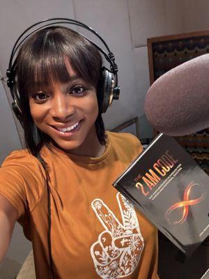 Author holds her book, The 2 AM Code. Narrating her audiobook produced by the Ardent Audio Productions.