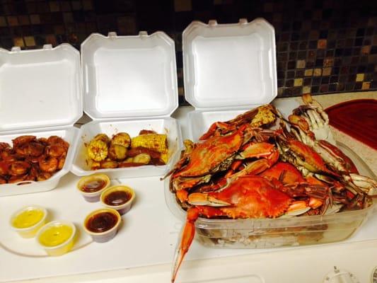 Bucket of blue crabs, snow crab leg clusters, steamed shrimp.