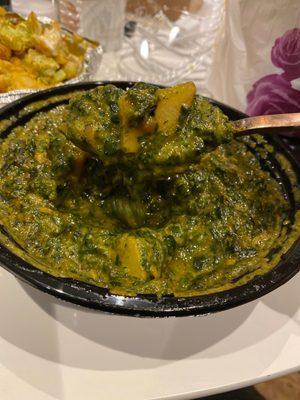 The Aloo Saag is slimy, overcooked, and rife with burnt garlic.