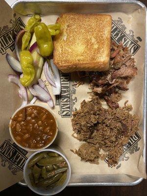 Two meat dinner with two sides, Texas toast, Pickles onions and peppers.   Pulled pork and beef brisket.