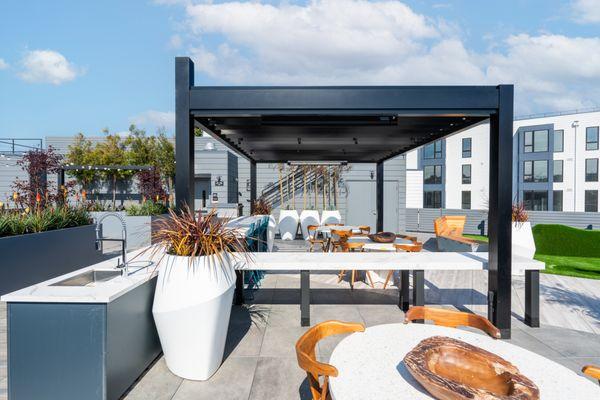 Roofdeck space with bar, tables, and seating