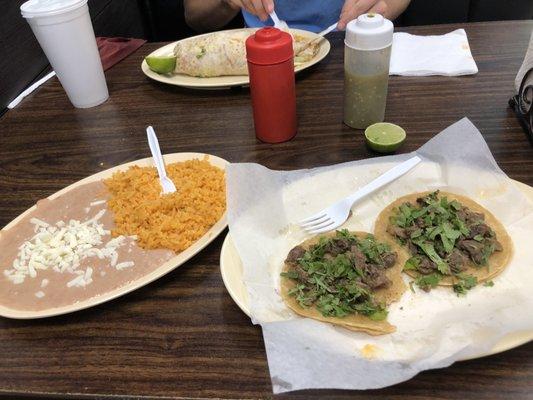 Steak taco with just cilantro and rice and beans!  This restaurant is so underrated. 10 out of 10 would eat again!