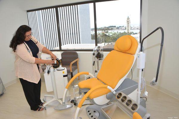 Dr. Sultan preping an exam room, Aloha tower and Honolulu Harbor in the background. State-of-the-art chairs keep our patients comfortable