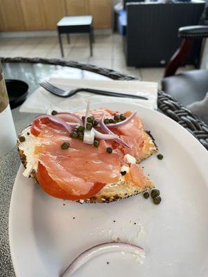 Lox cream cheese tomato red onion capers on an everything bagel