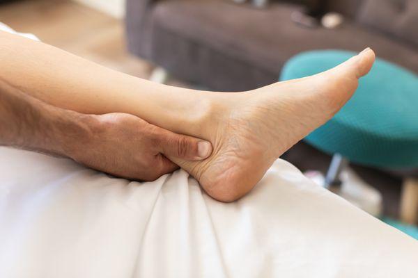 Our client having a therapeutic massage in Laguna Niguel for ankle pain. Therapeutic massage is great for pain relief and flexibility.