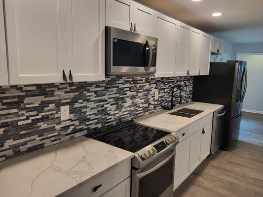 New cabinets, new lights, new countertops, and new backsplash!