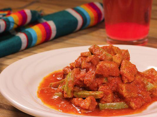 Chunks of pork and Nopales in a flavorful red salsa (Puerco y Nopales en salsa roja)