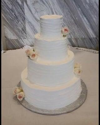 A four tier vanilla and chocolate wedding cake filled with strawberries and fudge.