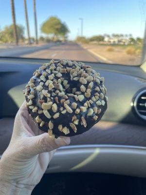 Chocolate cake donut with chocolate and peanuts