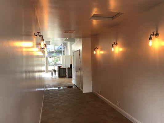 Very cool entrance, long hallway with industrial fixtures and LED Edison lamps!