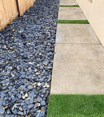 Decorative river rocks / stamped walkway / turf borders