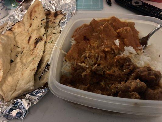 Naan . Chicken tikka masala in the top under the fork. The bottom is lamb curry. The "serving dish" was mine as I eat this as take home