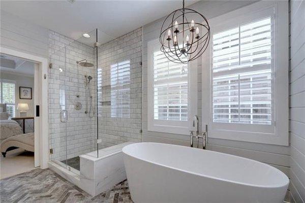 Travis Country master bath renovation - marble, shiplap walls, new windows, freestanding tub & an awesome chandelier