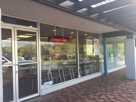 Storefront in small strip mall. Parking for shops.