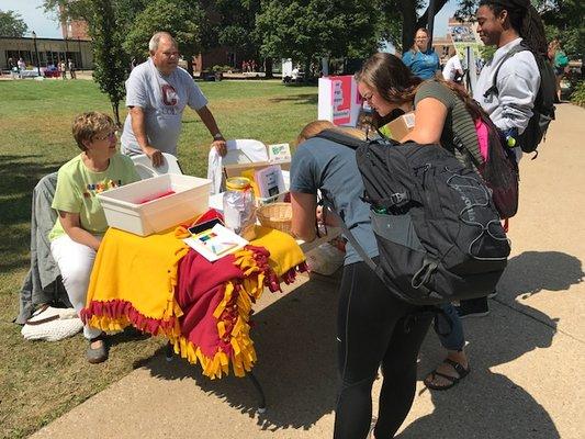 Volunteers from Westminster staff a table during Coe College's City Fest. Westminster is within walking distance from campus.