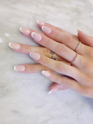 Almond Shaped Thin Arched French. A different take on the classic French nails. Looks very natural, you can't go wrong.