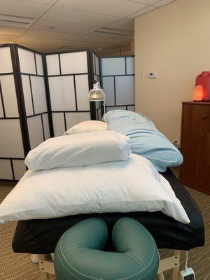 Treatment table with pregnancy pillow for side lying.