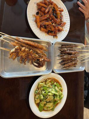 Beef skewers, cucumber salad, and eggplant in garlic sauce