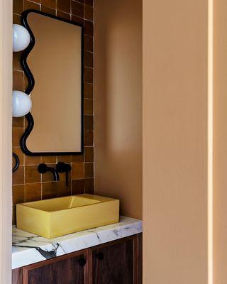 We built our client this custom black walnut vanity for the powder room addition.