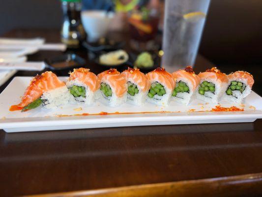 The Crunch Asparagus Roll. Salmon, Asparagus, with Garlic Chili Oil, Cucumber, Sesame sauce and Garlic Chips.