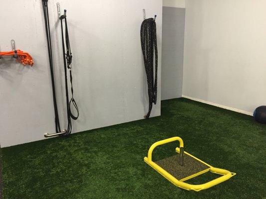 Battle ropes and sled push on the turf