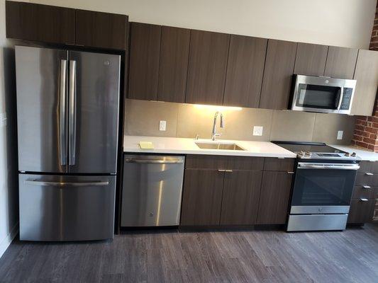 Kitchen with vey large fridge and soft closing cabinets.  Modern.