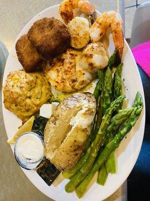 Crab cakes, shrimp, asparagus, and baked potato