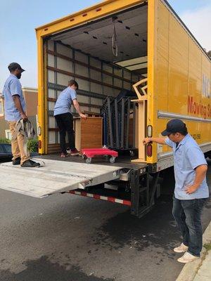 Our amazing crew, safely operating the lift gate on our 24ft truck