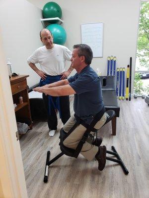 Dr. Campbell demonstrates an exercise for one of his patients.