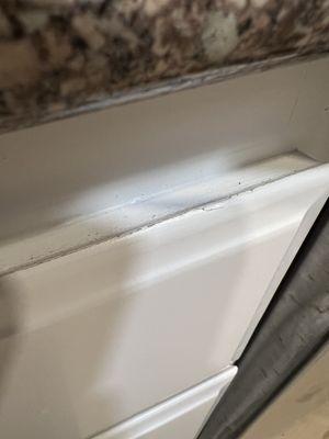 Cracking paint job on kitchen cabinets.