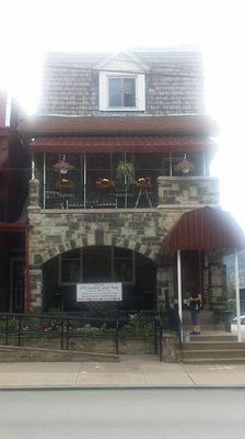 Solid Stone frontage, flower gardens, well kit signage.