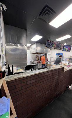 Cooking area. See the rotisseries with chicken and steak