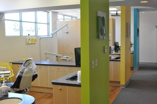 Treatment area with dental chairs. Movies are played on a TV located above each chair.