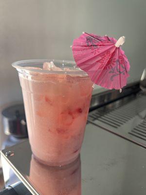 Strawberry Cooler made with fresh muddled strawberries, our homemade vanilla bean syrup, strawberry juice, and coconut milk.