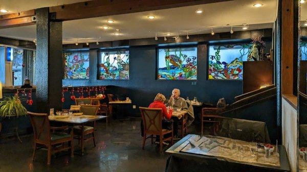 Restaurant seating with stained glass murals